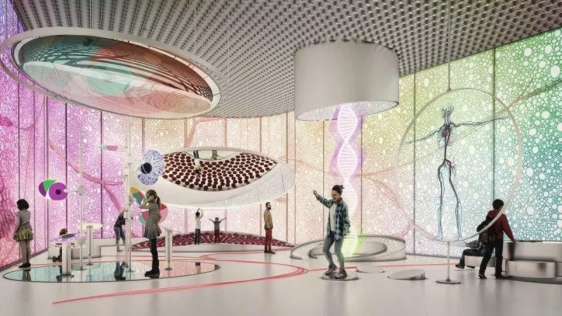 Wizualizacja przestawiająca pierwotny projekt wystroju wnętrz sali wystawy stałej. Grafika utrzymana w fioletowo-biało-zielonej kolorystyce prezentuje udządzenia oraz zwiedzających.